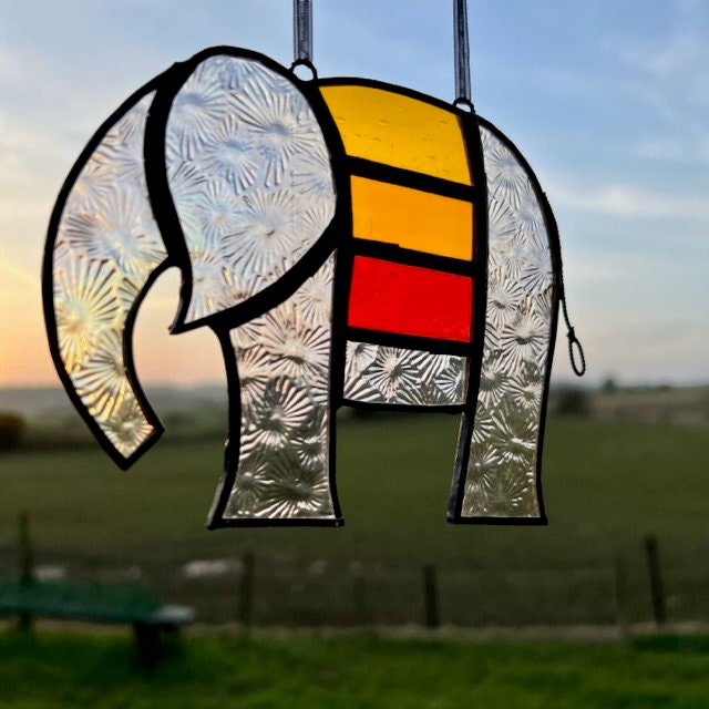 Pretty Elephant Stained Glass Suncatcher in warm golden tones with iridescent body ….