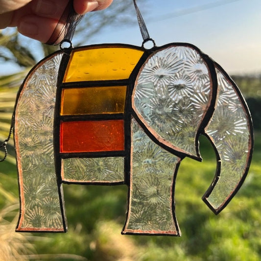 Pretty Elephant Stained Glass Suncatcher in warm golden tones with iridescent body ….