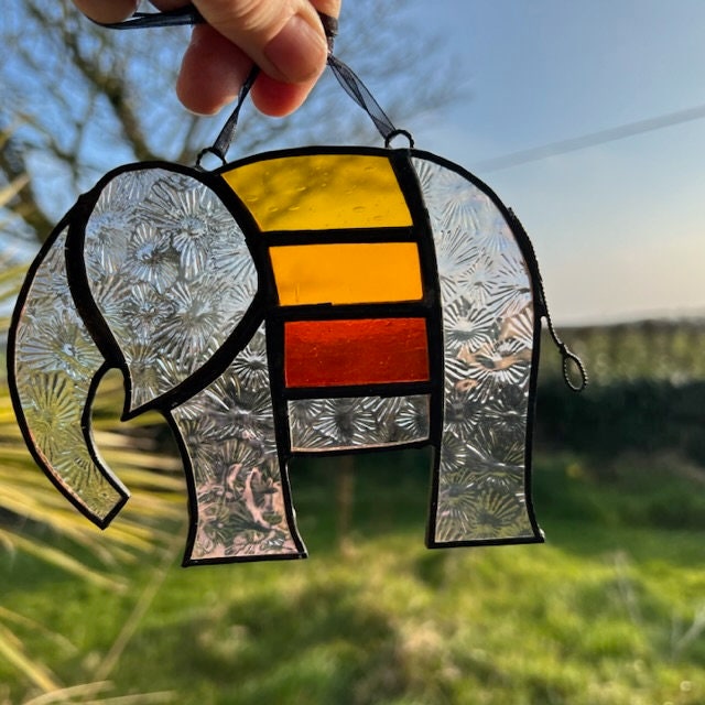 Pretty Elephant Stained Glass Suncatcher in warm golden tones with iridescent body ….