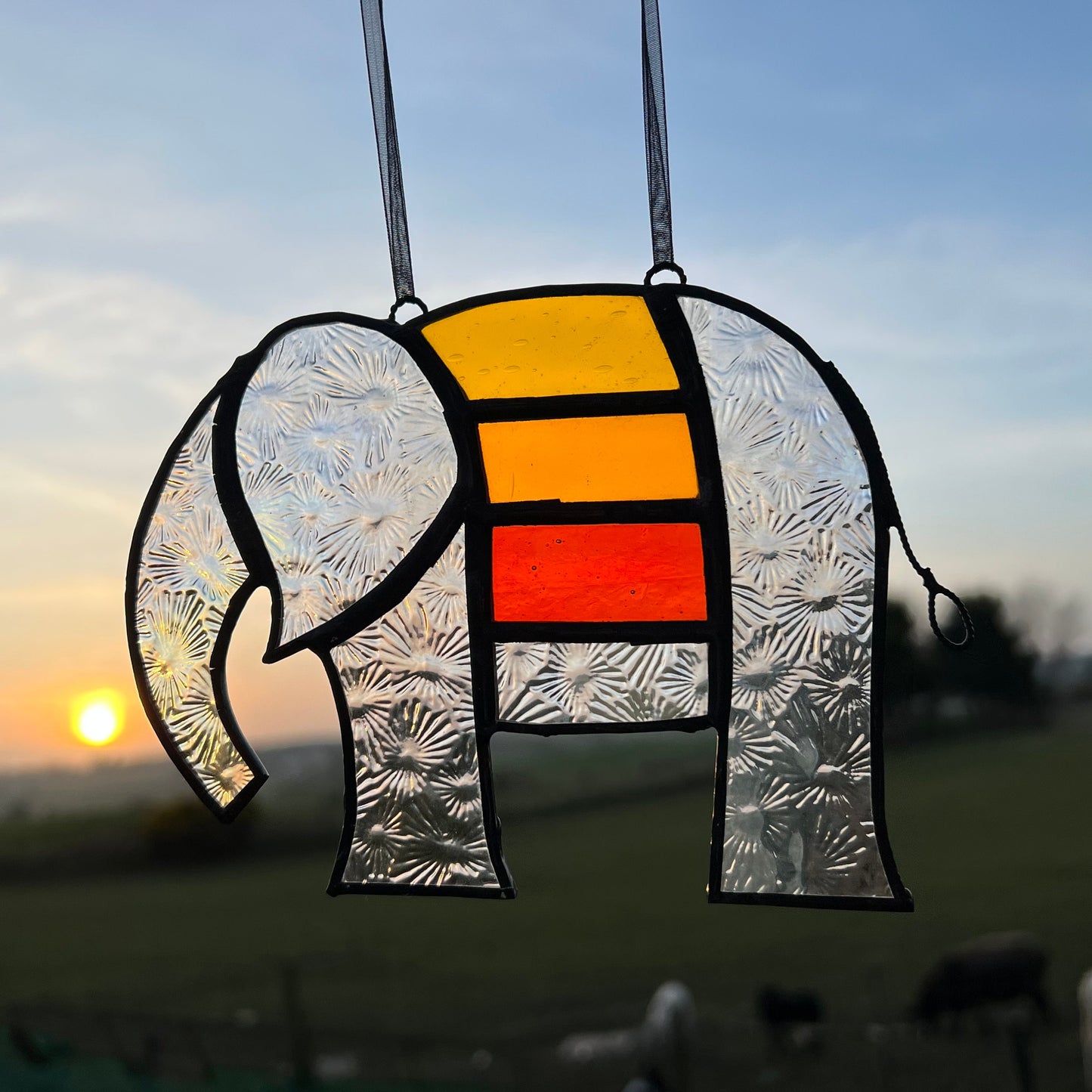 Pretty Elephant Stained Glass Suncatcher in warm golden tones with iridescent body ….