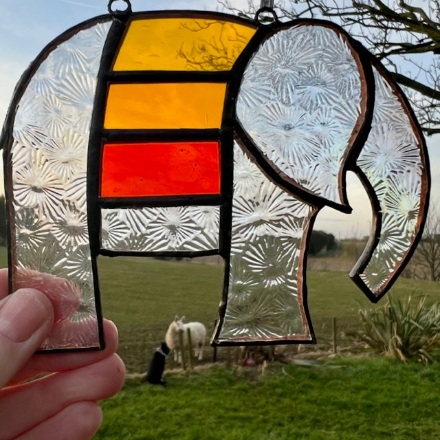 Pretty Elephant Stained Glass Suncatcher in warm golden tones with iridescent body ….