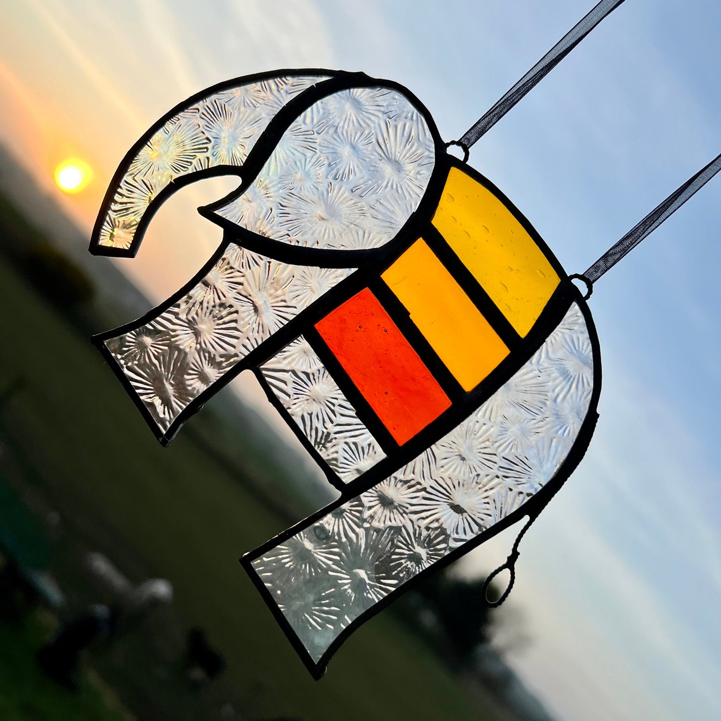 Pretty Elephant Stained Glass Suncatcher in warm golden tones with iridescent body ….